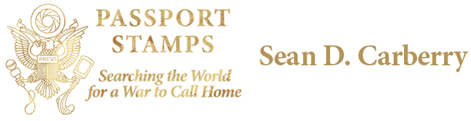 Passport Stamps: Searching the World for a War to Call Home by Sean D. Carberry. Logo shows a stylized eagle with a camera lens over its head, a mic in one claw and a bottle in the other.